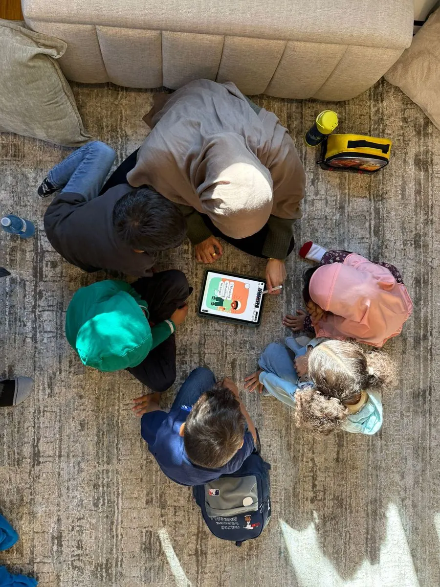 A small group learning together around a tablet