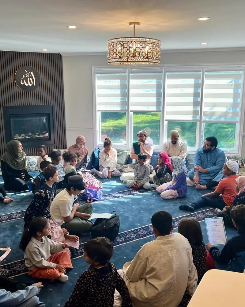 Families and children gathered in a learning circle at Al-Ihsan Learning Centre